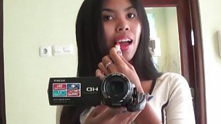 Sexy brunette Asian babe fools around with the cam
